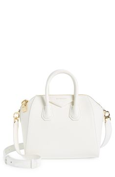 Beloved by street-style mavens the world over, Givenchy's Antigona satchel is updated in a chic, compact size. Top zip closure Top carry handles; removable, adjustable shoulder strap Interior zip and wall pockets Structured silhouette with flat base and protective leather feet Leather Made in Italy Designer Handbags Classic White Satchel With Top Carry Handle, White Evening Satchel With Double Handle, White Formal Satchel With Detachable Handle, White Double Handle Satchel For Evening, White Formal Shoulder Bag With Zipper Closure, White Double Handle Evening Satchel, Formal White Shoulder Bag With Zipper Closure, White Satchel With Gold-tone Hardware For Evening, Luxury White Shoulder Bag With Zipper