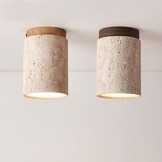 two concrete lamps hanging from the ceiling