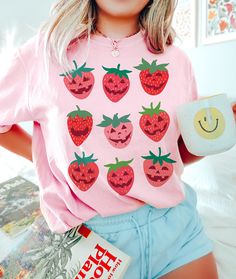 Strawberry Shirt Comfort Colors Halloween Shirt Please send a message if your desired color, size or garment style/brand is not available! Be sure to check the size chart within the listing. Most of the models are wearing oversized apparel. Size up from your usual size to achieve this look! TEE INFO/CARE: * Garment Dyed 100% cotton * Pre-Shrunk * Unisex, Loose fit * Wash inside out in COLD water * Lay flat to dry or machine dry on LOWEST setting * Iron on low * Do NOT dry clean Printed with eco- Novelty Pink Crew Neck T-shirt, Halloween Pink T-shirt With Screen Print, Pink Halloween T-shirt With Screen Print, Novelty Short Sleeve Shirt With Cartoon Print, Playful Pre-shrunk Tops For Halloween, Cute Orange Tops With Cartoon Print, Fun Strawberry Print Crew Neck T-shirt, Red Graphic Print Shirt For Halloween, Fall Kawaii Style Cotton Top