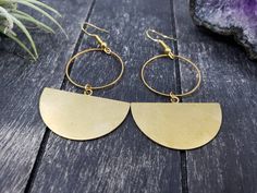 "These geometric statement earrings feature 35mm x 22.5mm raw brass half moon or semi-circle charms dangling from 25mm gold-plated brass circles. The ear wires are made from gold-plated surgical steel, making these earrings safe for sensitive ears. They are very lightweight and measure approximately 2.5 inches from the top of the ear wire to the bottom of the half circle charm. Domestic shipping is always free here at Mayamadethis! When will my item ship? Every single item here at MayaMadeThis i Modern Crescent Brass Earrings, Gold Semi-circle Brass Earrings, Gold Semi-circle Metal Earrings, Semi-circle Brass Earrings For Gifts, Modern Crescent Brass Hoop Earrings, Everyday Metal Crescent Earrings, Gold Brass Half Moon Earrings, Everyday Crescent Metal Earrings, Gold Half Moon Brass Earrings