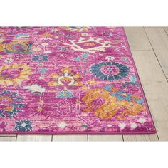 a pink rug with colorful flowers on it