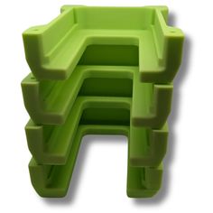 a green plastic object on a white background