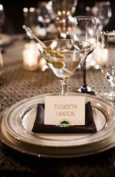 an elegant table setting with wine glasses and place cards