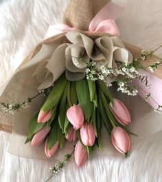 a bouquet of pink tulips and baby's breath