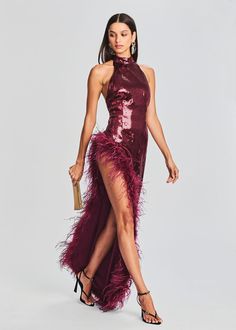 Elevate your glamour game with our Vixen Dress, a bold and breathtaking statement piece that exudes confidence and allure. With its halter neck, open back, and daring slit, this dress is designed to make you the star of any event. Shown here in Cabernet. 100% Polyester Made in China Model is 5'10" wearing size XS Style Sequin Long Dress, Wine Red Dress, Sequin Halter, Woman Wine, Sequin Maxi Dress, Sequin Maxi, Sequin Gown, Red Sequin, Feather Dress