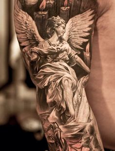 the back of a man's arm with an angel tattoo on it