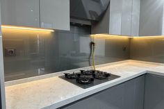 a stove top oven sitting inside of a kitchen next to white cabinets and counter tops