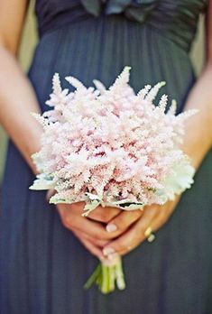 a woman holding a bouquet of flowers in her hands