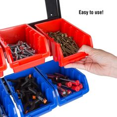 there is a person holding several bins with screwdrivers in them