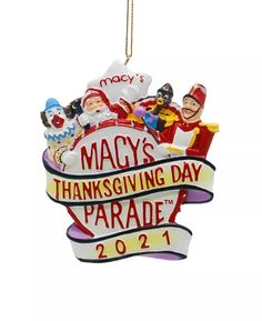 a christmas ornament hanging from a red and white frame with the words macy's thanksgiving parade on it