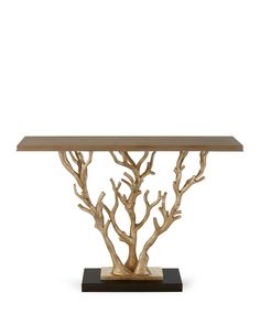 a wooden table with branches on it and a base for the centerpiece, against a white background