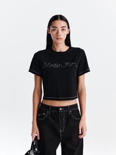 This is a casual and trendy t-shirt by Matin Kim that is made out of high quality and sturdy material. With distinctive mood of the design and comfortable wear, you can style it for your casual daily outfit.- MATIN KIM logo stitch detail- Cropped length and natural fit- Woven label point on the back Modern Black Crew Neck T-shirt, Fitted T-shirt For Streetwear, Modern Fitted T-shirt With Graphic Print, Modern Short Sleeve Top With Logo Print, Tan T-shirt For Spring Streetwear, Trendy Black Cotton T-shirt, Modern Black Crew Neck Top, Modern Black Short Sleeve Tops, Black Trendy T-shirt With Logo Print