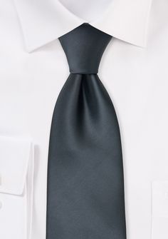 This dark smoke-gray tie can be the best option for you if you want an exquisite necktie but think a solid black tie is a little too stiff. This tie has a fantastic satin sheen. It is a tie that works well with both business clothing and semi-formal gatherings. The colours grey, white, and black go well with this tie. Elegant Black Suit And Tie Accessories For Office, Classic Gray Tie For Black Tie Events, Solid Black Tie With Satin Finish, Solid Black Tie Standard Tie, Solid Color Standard Tie For Black Tie Events, Elegant Gray Suit And Tie Accessories For Formal Occasions, Elegant Black Tie For Office, Elegant Gray Suit And Tie Accessories For Office, Elegant Black Office Ties