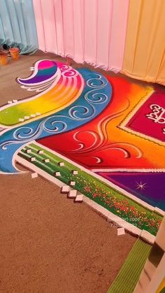 a colorful carpet is being painted on the ground