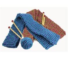 three knitted items with knitting needles and yarn