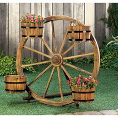 a wooden wheel with flower pots on it