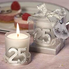 a white candle sitting on top of a table next to a box filled with cake