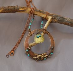 https://www.etsy.com/shop/thestonewind/ Hand-made in Northern California: unique, original design, hammered copper and gemstone jewelry.   Stone Wind "Dragons in the Mist"  Unique and one-of-a-kind, hand made, copper (metal) circlet amulet decorated with a small brass (metal) dragon lizard,  turquoise beads, and two brass (metal) drops.  Wonderful and unique gift for both men and for women. This is a one of a kind, hand made, pendant necklace. Necklace length is adjustable by removing desired number of links from chain to shorten. Necklace is not soldered, welded, glued, riveted or electroplated. Necklace is constructed solely by hand using wire wrap and wire weave copper. Includes white swirl, cotton-insert, gift box for your gifting needs. Our goal is 100% customer satisfaction to earn y Rustic Copper Jewelry For Festivals, Bohemian Jewelry In Copper Wire With Patina, Adjustable Copper Amulet Jewelry, Adjustable Copper Amulet Necklace, Bronze Brass Amulet Necklace, Bronze Copper Amulet Jewelry, Wire Wrapped Amulet Pendant Crystal Necklace, Metal Drop, Dragon Figurines