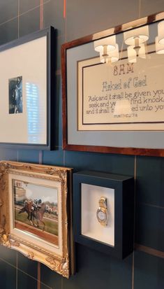 two framed pictures hang on the wall next to each other in a blue tiled room