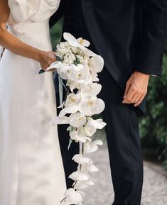 a bride and groom standing next to each other