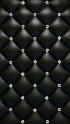 an up close view of a black leather wall with diamond studs and rivets