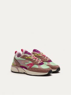 a women's sneaker with pink and green accents on the upper part of the shoe