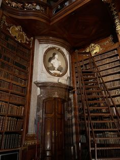 an old library with many bookshelves and a clock on the wall above it