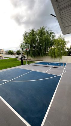 an outdoor basketball court with blue and white lines