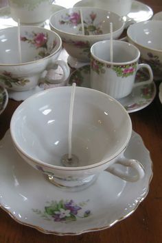 tea cups and saucers are arranged on a table