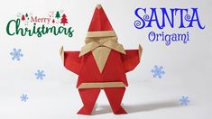 an origami santa clause standing in front of snowflakes