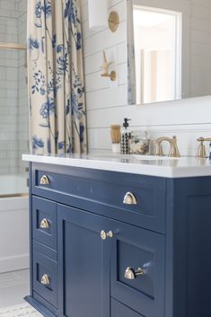 a bathroom with blue cabinets and white walls