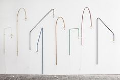 an assortment of different colored handles on a white wall