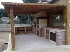 an outdoor kitchen is built into the side of a house