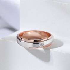 Confidently declare your love with this classic band. Created in two tone sterling silver and adorned with a round stone, this band is a lovely symbol of two hearts united as one. Simple in design, the band is finished with a bright polished shine. Never miss it.Carat Weight: 0.04 ctStone Size: 2 mmStone Type: Jeulia® StoneNumber of Stones: 1 Weight: 3.7 gWidth: 4.7 mmHeight: 1.4 mmThickness: 1.4 mmMaterial: 925 SilverPlating Color: Silver, Rose Gold Classic Round Band Jewelry For Anniversary, Elegant Rose Gold Sterling Silver Couple Rings, Rose Gold Round Cut Couple Rings For Anniversary, Rose Gold Couple Rings For Anniversary, Classic Double Band Anniversary Jewelry, Classic Double Band Jewelry For Anniversary, Silver Jewelry With Single Diamond For Anniversary, Fine Jewelry Rose Gold Couple Rings For Anniversary, Elegant Couple Rings With Single Diamond For Anniversary