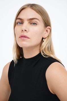 Modernism and minimalism collide in our Venus Drop Earrings. With a sleek profile and a reflective finish reminiscent of brilliant city lights, these sterling silver drop earrings are handcrafted to make your style shine day after day, night after night, season after season. Each pair includes a Marcella-branded vegan leather travel case for safe storage and easy travel.[SPLIT] Available in one size. Approximately .75” (2 cm) long. 18KT yellow gold plated brass. In silver, rhodium plated brass. Swim Jewelry, Tunic Hoodie, Sterling Silver Drop Earrings, Safe Storage, Easy Travel, Day Night, Silver Drop Earrings, Leather Travel, Gold Drop Earrings