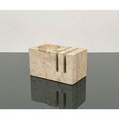 an object made out of concrete sitting on top of a table