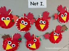 some paper plates with red birds on them and one has a stick in the middle