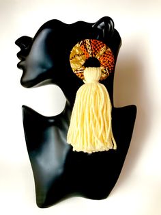 "Soft golden yellow stud earrings with a soft yellow cotton tassel. Fabric is interspersed with metallic gold. These are super-soft to the touch as they rest at your shoulders. Perfect to jazz up a jeans and blouse combo, a maxi-dress, or to coordinate with your kente patterned clothing or many shades of yellow. 5\" long." Summer Gold Tassel Earrings, Adjustable Gold Tassel Earrings With Fringe, Yellow Fringe Tassel Earrings, Yellow Fringe Earrings For Summer, Gold Fringe Earrings For Summer, Yellow Fringe Jewelry Gift, Yellow Fringe Jewelry For Gift, Yellow Fringe Jewelry For Party, Elegant Yellow Fringe Earrings