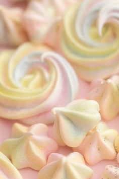 there are many different colored candies on the table together, including one with white and pink swirls