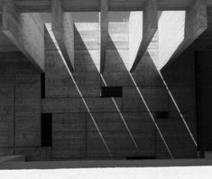 black and white photograph of stairs leading up to an open space with concrete walls in the background