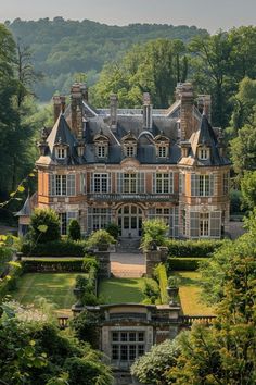 an aerial view of a large house surrounded by trees