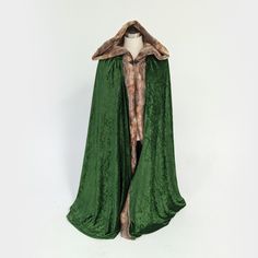 This beautiful hooded cloak is the perfect costume accessory for any medieval, Viking, huntress, or barbarian cosplay outfit. These cloaks are made with 2 layers of green velour fabric trimmed with soft brown/amber faux fox fur. The hood is extra large with green velour outside and lined with faux fox fur for dramatic effect. * * * OPTIONAL MATCHING FOX FUR HAND MUFF * * *Hand muff is made from same faux fox fur with satin liner and leather strap. Sizing: Kids - 30" long (not including hood)Adul Gothic Winter Larp Costumes, Medieval Outerwear For Winter Cosplay, Hooded Cape For Winter Costume Party, Hooded Outerwear For Fantasy Events In Winter, Hooded Medieval Outerwear For Halloween, Hooded Winter Cape For Costumes, Hooded Winter Cape For Costume Events, Fantasy Winter Costume Outerwear, Fantasy Costume Outerwear For Winter