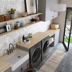 a washer and dryer in a small room with tile walls on the wall