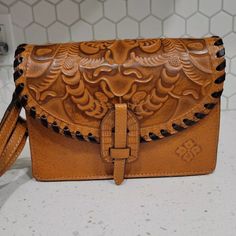 Patricia Nash Lanza Tooled Leather Convertible Crossbody Wristlet Bag Browncarry It As A Crossbody Or A Clutch. 100% Full-Grain Leather Interior: 1 Center Zip Compartment, 6 Credit Card Slots, 1 Zip Pocket, 2 Slip Pockets; 100% Polyester Exterior: 1 Rear Zip Pocket, 1 Slip Pocket Under Front Flap Push-Lock Closure Signature Brushed Metal Hardware, Heavy Handcrafted Stitching. Dimensions: 9"(W) X 7"(H) X 2 3/4"(D) Strap Drop: 23" - 26" Leather Crossbody Clutch With Mobile Phone Bag, Leather Crossbody Clutch With Phone Bag, Handheld Soft Leather Clutch, Brown Leather Clutch With Mobile Phone Bag, Leather Top Handle Clutch For Mobile Phone, Handheld Leather Pouch With Adjustable Strap, Handheld Pouch With Detachable Strap, Brown Crossbody Clutch With Removable Pouch, Brown Clutch Wallet With Detachable Strap