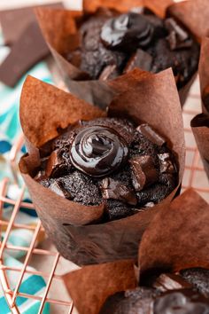 chocolate cupcakes sitting on top of a cooling rack