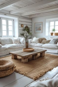 a living room filled with white furniture and lots of natural wood planks on the walls