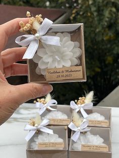 someone is holding up their wedding favors