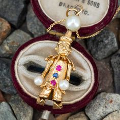 This awesome kinetic clown pendant features a moving head, arms, and legs and is accented with pearls and lab created ruby and sapphire. The necklace is crafted in 14k yellow gold and is 18 inches long. Ruby And Sapphire, Brand Presentation, June Birth Stone, Cultured Pearls, High Quality Jewelry, Estate Jewelry, Ruby, Sapphire, Lab