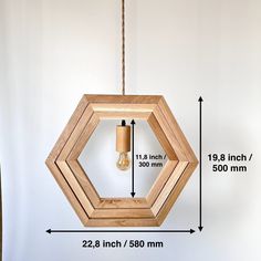 a wooden light fixture hanging from a ceiling with measurements for the size and length below it