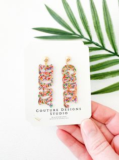 These super fun and sparkly Birthday Girl Earrings are perfect for gifting or keeping for yourself!  They are such a fun way to celebrate a birthday! Each pair of earrings are made using a a bright multi colored glitter acrylic that says BDAY and GIRL. The total length of these earrings measure approximately 2 inches long and .6 inches wide. They are set using your choice of Stainless Steel Silver or Gold Ball Posts OR lead free and nickel free ear wires (suitable for even sensitive ears) in a G Cute Party Earrings For Mother's Day, Cute Earrings For Mother's Day Party, Fun Dangle Earrings For Party, Playful Multicolor Earrings For Birthday, Cute Earrings For Birthday And Mother's Day, Cute Earrings For Birthday Or Mother's Day, Trendy Birthday Earrings For Pierced Ears, Playful Personalized Multicolor Earrings, Playful Multicolor Personalized Earrings